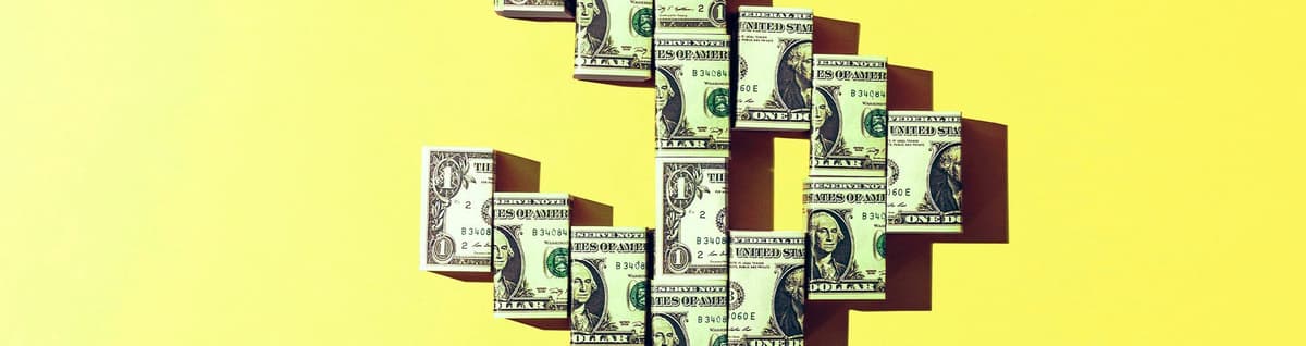 notas de dólar posicionadas formando símobolo $